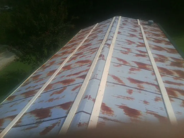 Rusted metal roof panels with new wood purlins before replacement — Storm Damage Roof Repair in Marysvale by Roofing Brothers