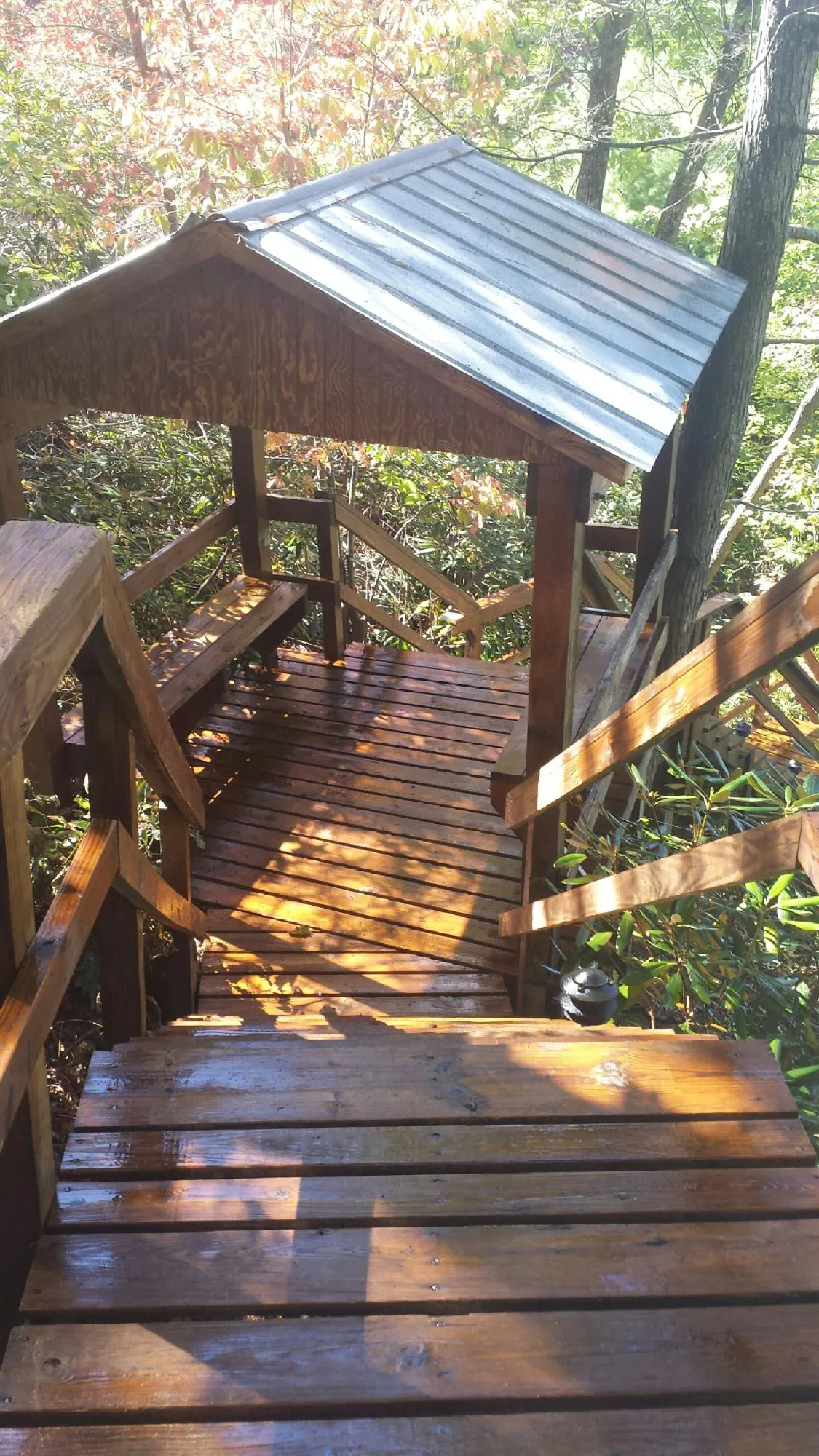 Freshly stained wood walkway and covered shelter with a metal roof in Marysvale